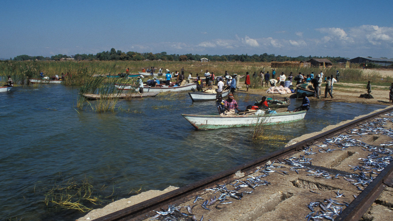 Fishing boats putting out from a shore.