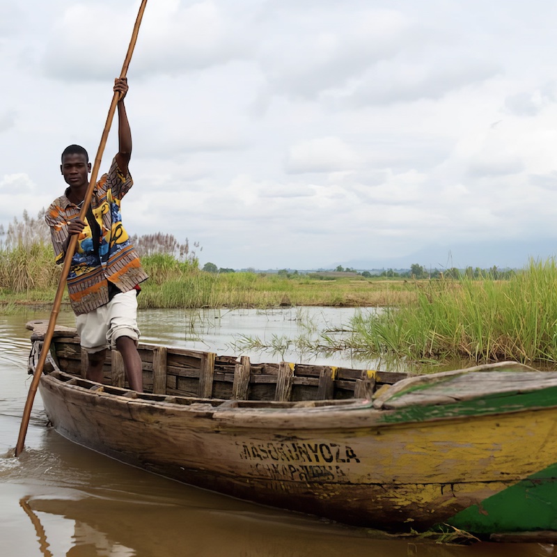 Man poling a mokoro (canoe).